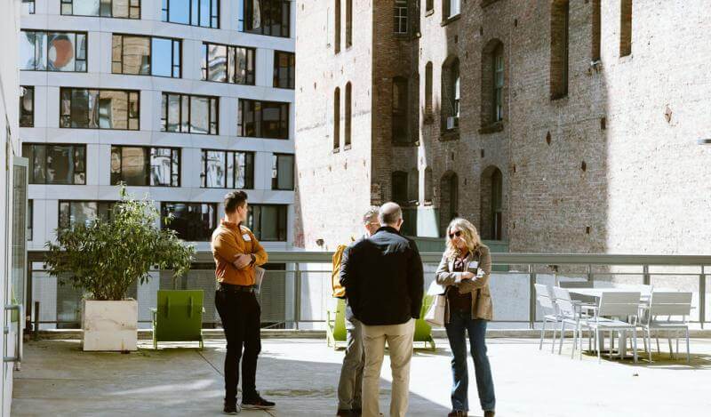 TNDC celebrates Ambassador and Rits grand opening with city officials