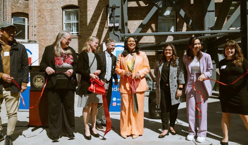 TNDC celebrates Ambassador and Rits grand opening with city officials