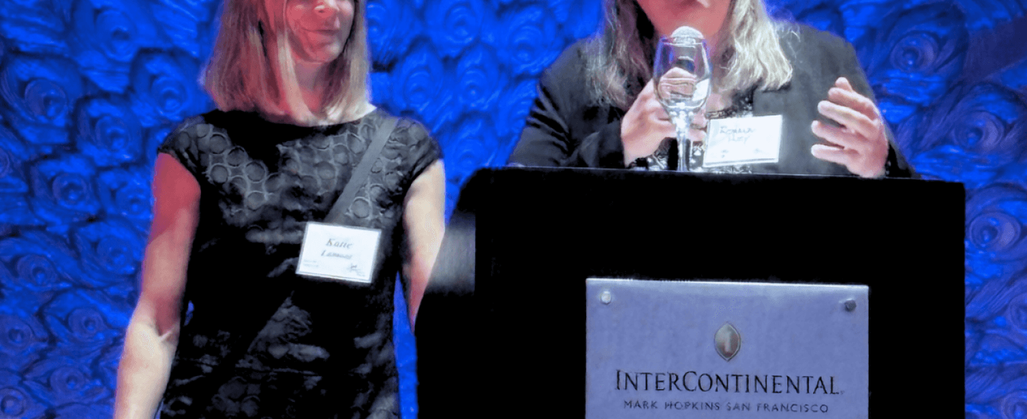 Roxanne Huey and Katie Lamont accept award from Curry Center