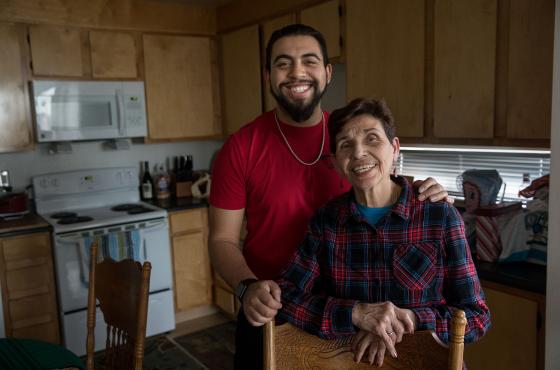 Nicaraguan Grandma and grandson pose together in kitchen